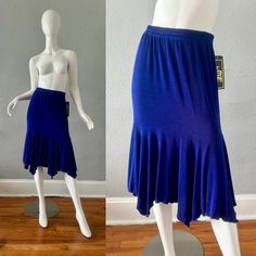 V I N T A G E 1990s . Unlined . Nwt . Elastic Waistband . Fairy Asymmetrical Hem . Below Knee Length . Slinky, Stretch C O L O R S . Indigo Purple M A T E R I A L . Acetate | Spandex L A B E L . Atoc A Touch Of Class C O N D I T I O N . Some Fading On 1 Side Of The Bottom Of Skirt (See Pics) Nwt! Excellent Otherwise S I Z E . Tag Size // S-M . Recommended Size // S-M M E A S U R E M E N T S (Not Stretched) . Waist // 27-40 . Hips // 36+ . Length // 25-29 ** All Items Were Measured Laying Flat & Fitted Denim Skirt, Plaid Pleated Mini Skirt, Asymmetrical Midi Skirt, Maxi Skirt Boho, Animal Print Skirt, Fringe Skirt, Wrap Around Skirt, Asymmetrical Skirt, Black Mini Skirt