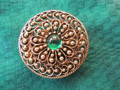 With intricate openwork surrounding a bright green glass cabochon, this bohemian brooch is a standout. Brooches are back, but this is convertable to a coat or hat pin if you want to use it that way.  It is a wonderful retro piece that will bing a pop of color gloomy winter days and fit right in with spring and summer. Measuring a bold 1 7/8" in diameter, and at over 3/4 of a century old, it is still in very nice condition, so typical of the quality of ART jewelry. Sidenote:  you hardly ever see Green Round Brooch For Formal Occasions, Green Round Brooches For Wedding, Vintage Green Brooch For Formal Occasion, Green Round Brooch For Gift, Green Round Wedding Brooches, Vintage Green Brooches For Formal Occasions, Antique Green Brooches For Wedding, Handmade Green Brooches For Formal Occasions, Green Round Brooches For Gift