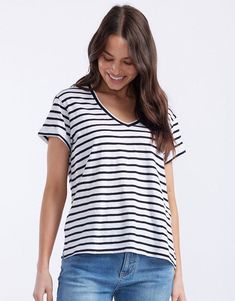 DESCRIPTION Add a touch of classic style to your wardrobe with the Turn Back Vee Neck T-Shirt in White/Black Stripe by White & Co. The Label. This timeless striped tee features a flattering V-neckline and a relaxed fit, perfect for everyday wear. The turn back cuffs add a chic detail that elevates the overall look, making it a versatile piece for any outfit. Whether you’re layering it under a jacket or wearing it on its own, this T-shirt promises both comfort and style. Pair this striped tee with blue jeans and white sneakers for a laid-back, casual look. For a more polished outfit, tuck it into a black midi skirt and add some bold accessories. This T-shirt is ideal for creating effortlessly stylish look for any occasion. Still browsing? Discover our full range of women's clothing. FEATURE Cotton V-neck Tops With Contrast Stripes, Cotton V-neck Top With Contrast Stripes, Striped Cotton V-neck T-shirt, Black T-shirt With Contrast Stripes, Bold Accessories, Black Midi Skirt, Black Midi, Striped Tee, White Sneakers