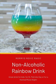 a rainbow drink in a wine glass with the words non - alcoholic rainbow drink on it