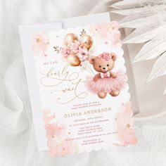 a pink and gold teddy bear themed baby shower with flowers on it's head