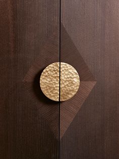 a wooden door with a metal object on it's front and side paneling