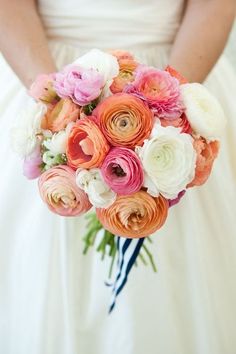 a bride holding a bouquet of flowers in her hands