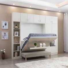 a living room with white furniture and a loft bed in the middle of the room