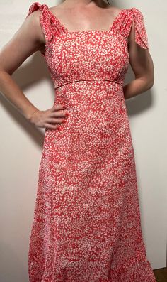 This floral maxi dress is the stuff of dreams! It is Union Made and from the 1970's, made predominantly of cotton and polyester. It's a gorgeous dress and perfect for spring and summer! It is a coral pink color with a white floral pattern on it. It is closest to a modern day size 2/4, but here are the exact measurements taken lying flat and doubled: Shoulders: 15 inches Chest: 28 inches Waist: 24 inches Hips: 30 inches Shoulders to Hem: 50 inches This dress has an inner lining too, so it keeps i Spring Sundress Maxi Dress, Retro A-line Maxi Dress, Spring Orange Lined Maxi Dress, Spring Lined Empire Waist Maxi Dress, Spring Empire Waist Lined Maxi Dress, Spring A-line Orange Maxi Dress, Spring Pink A-line Maxi Dress, Retro Orange Maxi Dress For Summer, Orange Retro Maxi Dress For Summer