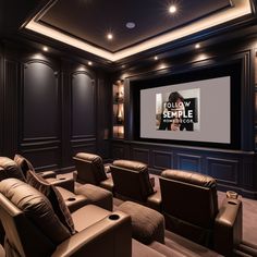 a home theater with leather recliners in front of a large screen and built - in speakers