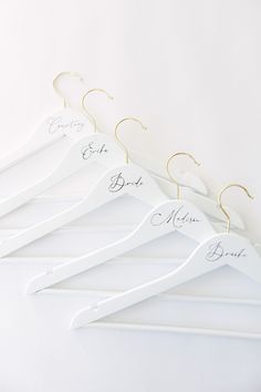 five white hangers with names on them