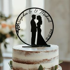 a wedding cake with a silhouette of a bride and groom