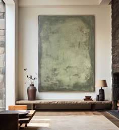 a living room with a large painting on the wall