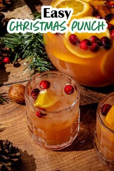 an easy christmas punch recipe with oranges and cranberries in the middle, garnished with pine cones