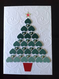 a christmas card with a tree made out of hearts on the front and bottom of it