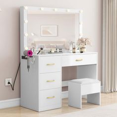 a white vanity with lights on it next to a mirror and stool in a room