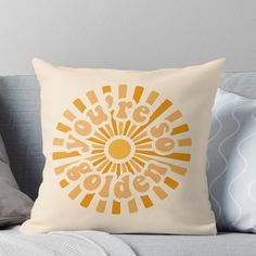 an orange and yellow throw pillow on a couch