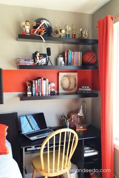 a bedroom with a desk and shelves filled with books