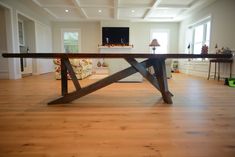 a wooden table sitting on top of a hard wood floor