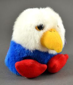 a stuffed toy bird with red, white and blue feathers