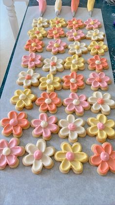 the cookies are decorated with pink, yellow and orange flowers