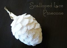 a piece of white lace is on top of a black surface with the words scalloped lace pinecone