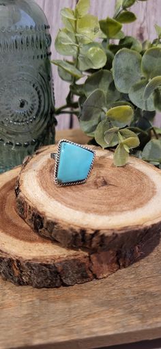 This unique shaped Turquoise Ring is made by Navajo Silversmith Artist Sheena Jake.  The vibrant blue stone is set in a smooth sterling silver bezel with twisted rope design surrounding it.  This ring the perfect gift for a friend or spouse for any special occasion! ★Specifics★ Metal: Sterling Silver Size of Ring: 8.75 (slightly adjustable) Weight: 6g Hallmarked: No Hallmark ★  Free shipping on all orders! We ship with UPS and always include tracking. All orders ship within 2 days of payment. ★ Western Style Blue Turquoise Ring In Sterling Silver, Western Style Blue Turquoise Sterling Silver Ring, Western Style Turquoise Gemstone Rings, Southwestern Style Turquoise Ring, Adjustable Southwestern Turquoise Ring Nickel Free, Adjustable Southwestern Style Turquoise Ring Nickel Free, Adjustable Southwestern Turquoise Ring Nickel-free, Adjustable Blue Turquoise Western Ring, Adjustable Western Style Blue Turquoise Ring