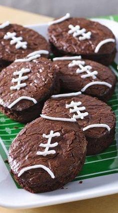 chocolate cookies decorated with footballs on a plate