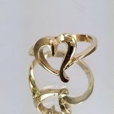 14k Gold Ring with a heart in the center. For only $289.00. Purchase comes with a gift box included. Ring size is adjustable, please note the size in the personalization section of checkout. Elegant Adjustable Heart Ring, Adjustable Gold Heart-shaped Initial Ring, Adjustable Gold Heart Initial Ring, Adjustable Yellow Gold Rings For Valentine's Day, Elegant Double Heart Rings For Formal Occasions, Adjustable Open Heart Anniversary Ring, Gold Sterling Silver Heart Ring For Wedding, Gold Heart Ring With Polished Finish For Wedding, Adjustable Yellow Gold Heart-shaped Rings