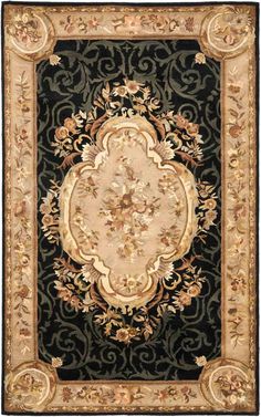 a black and gold rug with an ornate design on the bottom, surrounded by flowers