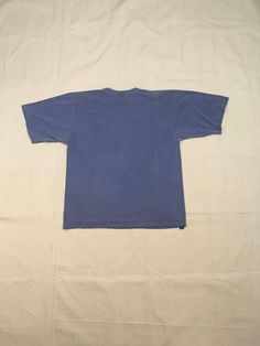 "1990s are neck t-shirt Fast Company cotton dyed blue, a little more muted then photos most like bottom tag 'fast' photo made in USA good vintage condition, light wear color fade, uneven bleached out spots fits like XL, labeled ML, see below measures, lying flat, shoulder-21 1/2\" chest-23 1/2\" sleeve-10 3/4\" length-29 1/2\"" Vintage Washed Blue Crew Neck Top, Blue Crew Neck Washed T-shirt, Blue Washed Crew Neck T-shirt, Blue Hand Dyed Crew Neck Top, Hand Dyed Crew Neck T-shirt For Streetwear, 90s Washed Relaxed Fit T-shirt, Hand Dyed Blue Graphic Tee, Blue Hand Dyed Graphic Tee, 90s Crew Neck Washed Tops