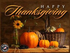 a thanksgiving card with pumpkins and sunflowers in a basket on a table