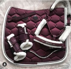 a purple and white horse saddle with accessories