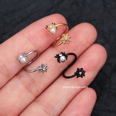 five different types of rings on someone's hand, all in different shapes and sizes