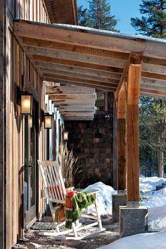 a white chair sitting on top of a snow covered porch