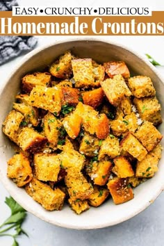 the best croutons recipe in a white bowl with herbs on top and text overlay