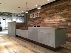 an office lobby with wooden walls and flooring