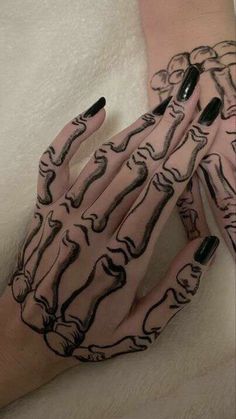 two hands with black and white designs on them