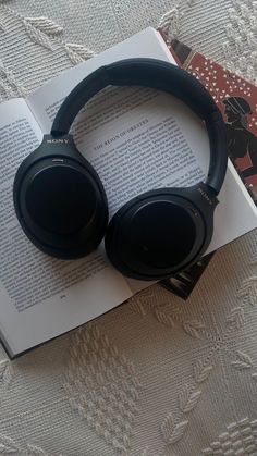 headphones resting on top of an open book