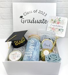 a graduation gift box filled with congratulations items