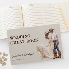 the wedding guest book is next to an open notebook