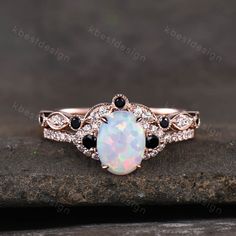 This is a beautiful lab created white fire Opal engagement ring in rose gold. Main Stone: 6x8mm oval cut opal. Side stone: Black cz diamond + white cz diamond. Wedding band: Curved band, Black cz diamond + white cz diamond. This ring is marked S925/G10K/G14K. I accept custom making order.Please contact me if you need this service. For all the jewelries,there is a 14 days money back guarantee.You can return it in the time frame without any questions.However there maybe handcrafted fee and shippin Ruby Engagement Ring Set, White Opal Engagement Ring, Opal Engagement Ring Rose Gold, Fire Opal Engagement Ring, Opal Engagement Ring Set, Opal Engagement Ring, Oval Cut Ring, Cute Engagement Rings, Opal Wedding