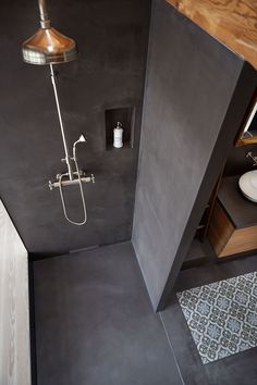 a bathroom with a shower, sink and mirror