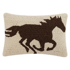 a brown and white pillow with a horse on it's side, in the shape of a running horse