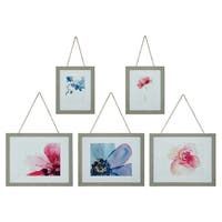 four framed pictures hanging on a wall next to each other with flowers in the middle