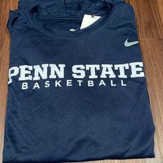 Nike Penn State Basketball T-Shirt. Brand New With Tags. Nike Navy Tops With Letter Print, Nike Navy Tops Team Spirit, Navy Nike Fan Apparel Top, Nike Navy Fan Apparel Top, Nike Navy Sports T-shirt, Nike Sports T-shirt In Navy, Nike Navy T-shirt With Graphic Print, Nike Navy T-shirt For Sports, Nike Blue Fan Apparel Tops