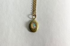 "This sweet, small, OVAL brass locket has a natural Ethiopian Opal cabochon set on the front.  The cabochon sits in a brass lace edged setting. It hangs on a 16\" gold-plated stainless-steel chain necklace.  The locket is approximately 11x16mm.  The cabochon is 5x7mm.  Arrives in an eco-friendly jewelry box, ready for gifting. MORE lockets in the shop! FREE SHIPPING! THANK YOU FOR VISITING!" Stainless Steel Chain Necklace, Eco Friendly Jewelry, Lace Edging, Steel Chain, Stainless Steel Chain, Antique Style, Ethiopian Opal, Locket, Jewelry Box