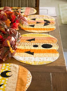 the table is set with placemats made to look like cats and pumpkins