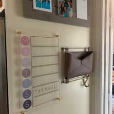 a bulletin board mounted to the side of a wall with magnets and pictures on it