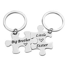 two pieces of puzzle keychain with the words big sister and little brother on them