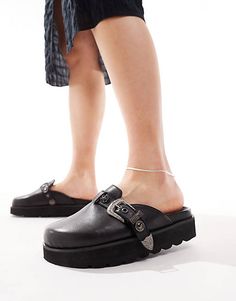 Trendy Closed Toe Mules With Heel Loop, Black Slip-on Mules With Metal Feet, Black Mules With Metal Feet And Round Toe, Black Pointed Toe Mules With Buckle Closure, Trendy Black Mules With Leather Footbed, Fall Slip-on Mules With Buckle Closure, Fall Buckle Closure Slip-on Mules, Faux Leather Closed Toe Platform Mules, Faux Leather Platform Mules With Closed Toe