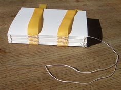 a pair of scissors is hooked up to a small box with yellow strips on it