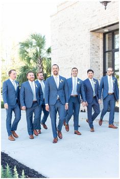 a group of men in suits and ties standing next to each other