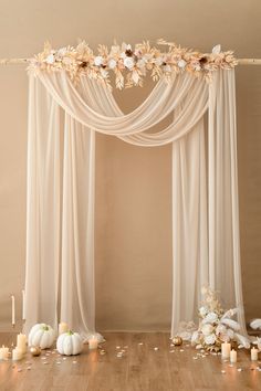 a wedding arch decorated with flowers and candles